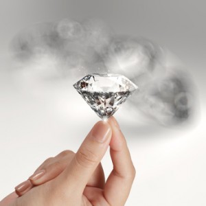 hand holding 3d diamond over grey background
